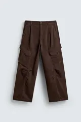 Pantalón cargo de corte relajado confeccionado en tejido de algodón con efecto lavado. Presenta cintura con pliegues frontales, bolsillos laterales con solapa en las perneras, bolsillos frontales y bolsillos traseros con solapa. Cierre frontal con cremallera y botón.
