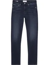 Jeans skinny de denim azul oscuro, tiro bajo, con cinco bolsillos y cierre de cremallera. Confeccionado con algodón reciclado y elastano.
