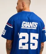 Remera deportiva azul con tecnología Dry, cuello en V, manga corta con estampado lettering y rayas contrastantes, estampado lettering NFL Giants.