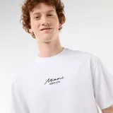 Remera blanca de manga corta y cuello redondo, de corte holgado, con un pequeño bordado en el pecho con la inscripción "Miami palm city".