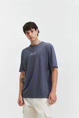 Remera de manga corta con calce oversize, color beige, con estampado floral y tipográfico en la espalda.