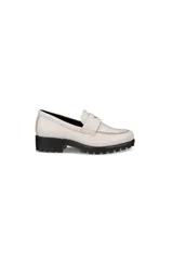 Mocasines blancos de cuero con suela track negra gruesa y tachas. Presentan el clásico detalle de tira con corte en el empeine.