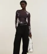 Pantalón negro de corte recto, con cintura ancha, trabillas y cinturón sintético.