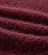 Cardigan abierto de punto pesado con textura peludita, manga larga y diseño alargado. Prenda versátil de corte holgado.