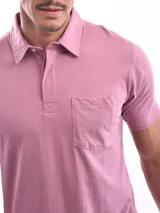 Remera polo blanca de corte regular, con cuello clásico, tapeta de dos botones y bolsillo de parche en el pecho.