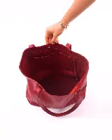 Bolso tote de cuero color bordó, con broche de cierre, bolsillo interior y porta llaves.
