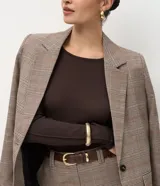 Suéter de punto color azul vibrante, con corte ajustado, cuello redondo y mangas largas. Presenta detalles de nervaduras verticales a lo largo de la prenda que estilizan la silueta.