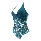 Malla entera de color verde oscuro, combinada con un diseño floreado en la parte inferior. Presenta escote halter cruzado y fruncidos en la zona del abdomen.