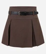 Short pollera de estilo sastre en color marrón, con diseño de pliegues frontales y cierre lateral. Incluye un cinturón desmontable de cuero sintético con hebilla metálica.