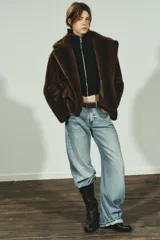 Abrigo corto de Zara con diseño de efecto pelo, cuello de solapa con muescas, manga larga y bolsillos frontales con solapa. Cuenta con forro interior a tono y cierre frontal con botón.