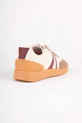 Championes deportivos para mujer Paddock modelo Aegon, con diseño en color blanco, detalles en beige y marrón tostado, y franjas laterales oscuras. Cuenta con suela de goma color camel y cordones blancos.