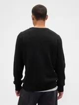 Buzo de punto con textura acanalada vertical, cuello redondo y mangas largas con puños elásticos.