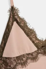 Vestido corto de tirantes finos ajustables con escote en pico. Presenta detalles de encaje en contraste en el escote y el ruedo. Cuenta con falda con vuelo y cierre de cremallera oculto en la espalda.