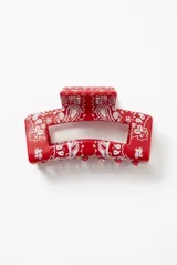 Broche para el pelo cuadrado, color rojo con estampado estilo paisley en blanco y diseño rectangular con abertura central.