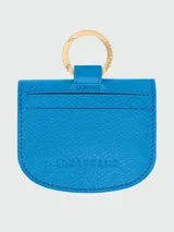 Tarjetero de cuero color azul, modelo Les Épure de Longchamp, con diseño abierto y cierres de botón a presión dorados.