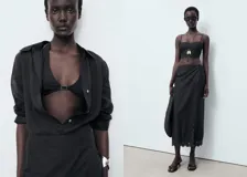 Falda midi recta de color negro, confeccionada en algodón con detalles bordados en el borde y cierre de cremallera lateral.