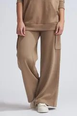 Pantalón deportivo de corte wide leg en color tostado, con diseño cargo que incluye bolsillos laterales. Confeccionado en tejido con elastano para mayor comodidad y libertad de movimiento.