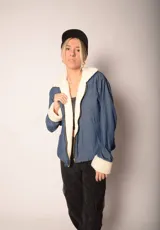 Campera azul de jean con interior de corderito blanco, cierre frontal y bolsillos laterales.