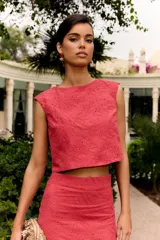 Top corto sin mangas color rosa fresa, con cuello redondo y diseño bordado con perforaciones en toda la prenda.