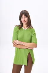 Remera de tejido de punto acanalado en color verde, con cuello redondo, mangas cortas y un tajo pronunciado en el frente.