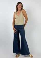 Pantalón de jean laminado color dorado, de corte palazzo.