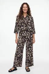 Camisa de manga larga con estampado animal print tipo leopardo, cuello camisero y cierre frontal de botones negros.