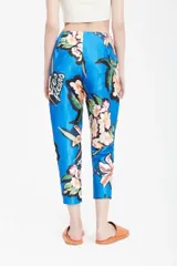 Pantalón sastre azul con estampado de flores y texto en blanco. Tiro alto, corte relajado, cintura pinzada y pierna recta.