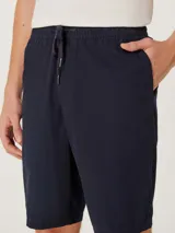 Bermuda azul marino de corte clásico y diseño liso, con bolsillos laterales y traseros.