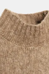 Chaleco de punto con lana, de cuello alto y diseño sin mangas con volantes en los hombros.