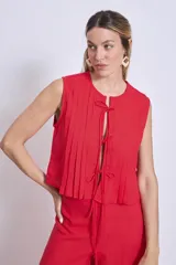 Blusa sin mangas color azul marino, con cuello redondo y detalle de tablas verticales en el frente. Corte holgado y corto.