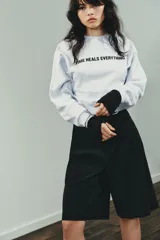 Sudadera negra de cuello redondo y manga larga, con texto blanco "SCREENWRITER & MAIN CHARACTER" en el delantero. Acabados en rib a tono.