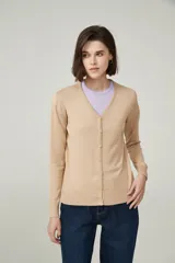 Cárdigan color beige con escote en V y cierre frontal con botones.