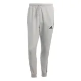Pantalón de jogging Adidas French Terry Pants, color gris melange con detalles negros, cintura elástica con cordón de ajuste, puños en los tobillos y logo de la marca estampado en la pierna izquierda.