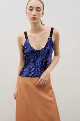 Top de fiesta sin mangas, confeccionado en lentejuelas azules con breteles negros contrastantes y escote redondo.