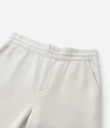 Pantalón jogger de algodón con felpa, color beige, con cintura elástica, cordón ajustable, bolsillos laterales y puños elásticos en los tobillos.