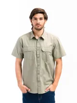 Camisa de manga corta color verde oliva, con cuello clásico, cierre frontal de botones y dos bolsillos frontales con solapa en el pecho.