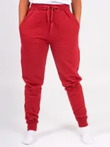 Pantalón tipo babucha de corte holgado, con cintura elástica ajustable mediante cordón, bolsillos laterales y puños elásticos en los tobillos.