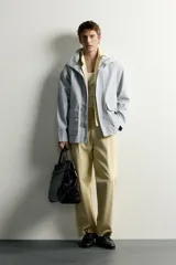 Parka relaxed fit de algodón con efecto lavado, color gris, cuello subido, manga larga y bolsillos de plastrón con solapa en el delantero. Cuenta con cierre frontal de botones y solapa.