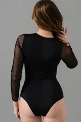 Body negro de manga larga confeccionado en encaje elastizado con diseño geométrico. Forrado en lycra color crudo en el interior.