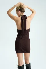 Vestido mini de punto roma color marrón oscuro, con diseño ceñido, escote halter drapeado pronunciado y laterales fruncidos.