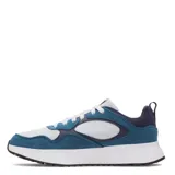 Championes Under Armour modelo Mirage Sport, con diseño deportivo en combinación de colores azul, blanco y detalles en azul marino. Presentan una estructura de malla transpirable con refuerzos de gamuza, entresuela blanca amortiguada y suela de goma negra.
