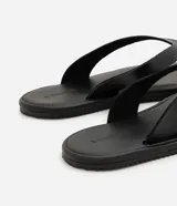 Sandalias de dedo para hombre, confeccionadas en material sintético con tiras anchas, diseño limpio, suela plana y acabado uniforme.