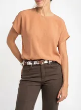 Blusa de manga corta, color terracota/naranja suave, con escote redondo y calce oversize.