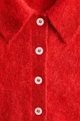 Remera polo de manga corta confeccionada en punto suave con mezcla de mohair y lana, color rojo, con cuello clásico, tapeta con botones frontales y ribetes acanalados.