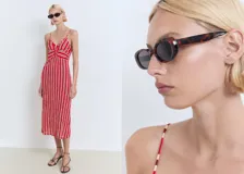Vestido midi de tirantes finos ajustables y escote en V, con diseño recto y detalle fruncido en el frente. Presenta un estampado de rayas verticales rojas y blancas.