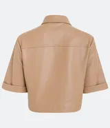 Camisa de manga corta confeccionada en cuero sintético color tostado, con cuello camisero, cierre frontal con botones en forma de corazón y dos bolsillos con solapa en el pecho.
