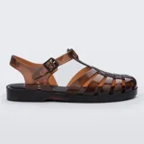 Sandalias Melissa modelo Possession, estilo pescador de color marrón translúcido. Confeccionadas en MelFlex vegano, cuentan con tiras entrelazadas, cierre lateral con hebilla ajustable y suela plana.