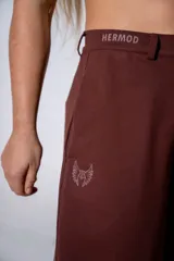 Pantalón sastrero de corte holgado y tiro alto, color marrón chocolate, con cintura elástica y lazo ajustable del mismo tono.