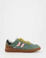 Championes Coolway modelo Goal, confeccionados en serraje verde con detalles en piel color rosa, marrón y negro. Presentan cordones planos color mostaza, suela de goma flexible y refuerzos con pespuntes en la puntera.