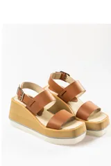 Sandalias de cuero color marrón con plataforma de madera y suela blanca.
